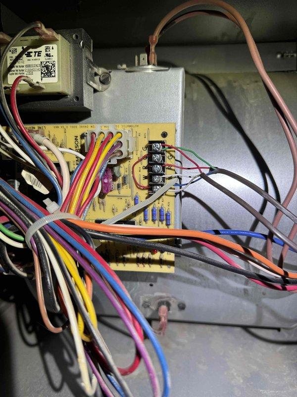 Responded to service call for non-operational air conditioning system. Upon inspection, accessed electrical component panel and control board to diagnose system failure. Evaluated JARD capacitor connections, transformer assembly, and control board wiring terminals. Documented existing system configuration including 13 SEER rating and previous service notations dated 4/5/15. Inspected all wire connections at capacitor terminals and control board, verifying proper routing of power and control wiring throughout the unit. System restored to operational status following diagnostic evaluation and component verification.