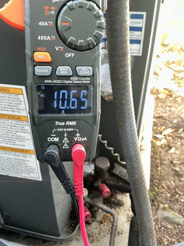 Responded to customer complaint of excessive noise from 5-year-old Goodman ASX140421KD air conditioning unit. Performed diagnostic inspection of outdoor condensing unit and verified manufacturer specifications on data plate. Measured operating amperage at 10.65 amps, which falls within normal parameters for the compressor and fan motor (MCA 21.8A, RLA 16.7A). Conducted visual and auditory assessment of unit during operation to identify source of increased noise levels. System confirmed to be running with proper electrical draw and R-410A refrigerant charge as indicated on nameplate. Documented equipment condition and operational readings with photographs for service records.