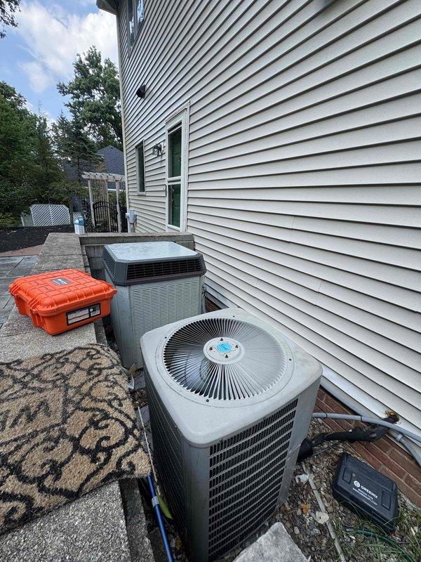 Responded to no cooling complaint on two residential AC units. Performed diagnostic evaluation on both systems. Upon inspection, identified failed dual run capacitor on one of the outdoor condensing units, exhibiting severe corrosion and deterioration at terminals. Replaced defective capacitor with properly rated component. Verified both systems restored to normal cooling operation and confirmed proper amperage draws on compressor and condenser fan motor circuits.