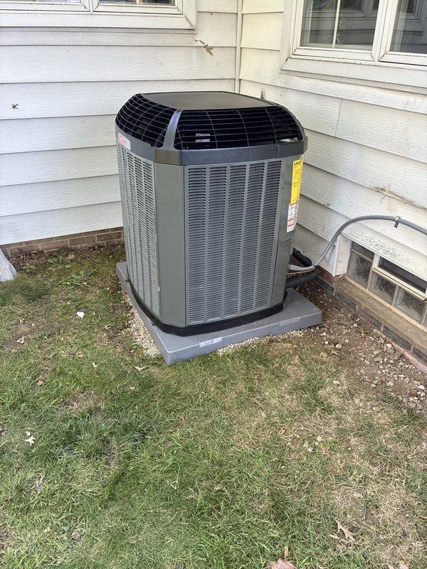 Completed full HVAC system installation including Trane furnace, air conditioning unit, and ductwork liner. Installed outdoor condensing unit on composite pad with proper refrigerant line connections and electrical conduit routing to exterior wall, positioned furnace in basement mechanical room on concrete block base with insulated plenum and ductwork, and established PVC condensate drainage and venting system. All equipment installed per manufacturer specifications with proper clearances, sealed duct connections, and system tested for operational performance.