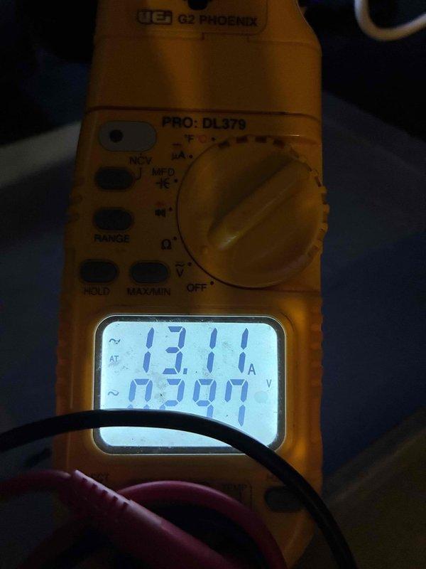 Performed routine maintenance on 20-year-old HVAC system including filter replacement and comprehensive system inspection. Measured operating amperage at 13.11A and voltage at 0.300V using digital multimeter to verify electrical performance. System found operating within normal parameters with no issues identified during tune-up service.