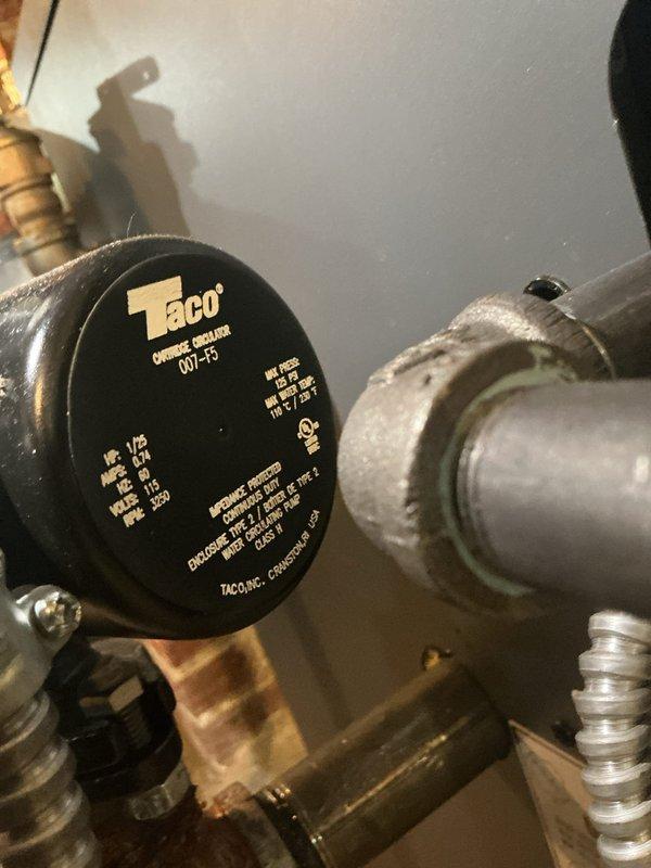 Responded to service call for reported leak on 4-month-old boiler installation. Upon inspection, discovered severe corrosion and active deterioration on steel piping connected to the Taco 007-F5 circulator pump. The vertical pipe section and elbow joint exhibited extensive rust formation and surface flaking, indicating premature failure likely due to improper material selection or water chemistry issues for a recent installation. Documented conditions with photographs showing the corroded fittings, circulator connections, and affected piping assembly. Identified that ferrous piping was experiencing accelerated oxidation inconsistent with the boiler's age, suggesting potential installation defect or incompatible materials used in the hydronic system.