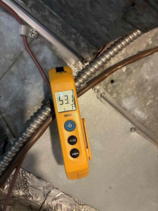 Responded to service call for thermostat displaying error message and unable to read outdoor temperature. Upon inspection, found blower wheel assembly heavily soiled with dust and debris accumulation affecting system operation. Measured supply air temperature at 53.1°F to verify cooling functionality. Diagnosed thermostat communication issue related to outdoor sensor malfunction and addressed system airflow concerns due to contaminated blower wheel and filter media requiring maintenance.
