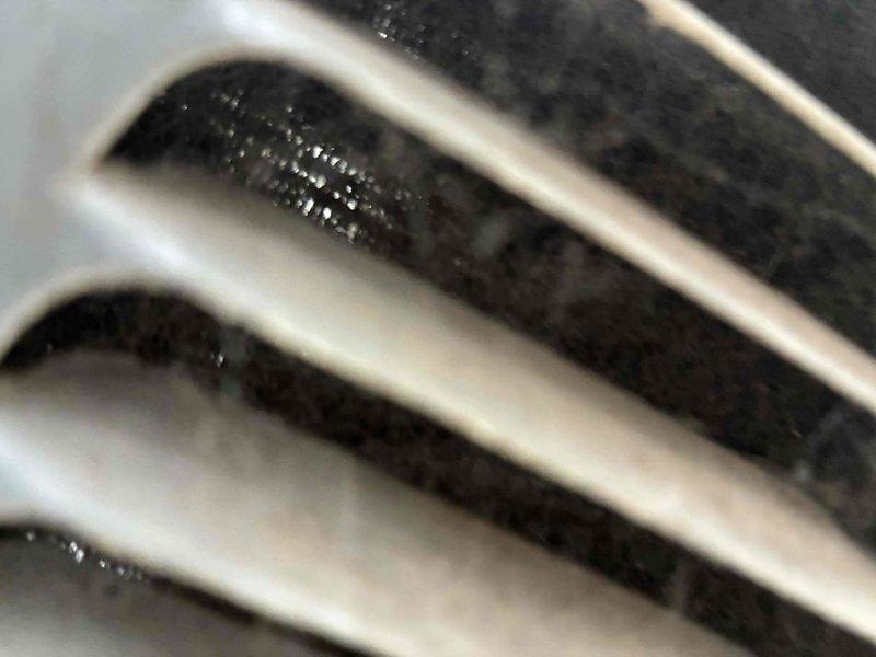 Responded to service call for attic air conditioning unit causing water leakage through kitchen ceiling in three locations following recent maintenance visit. Inspected evaporator coil and condensate drainage system, identifying blocked condensate drain line as source of overflow. Cleared obstruction from primary drain line, verified proper drainage flow, and tested condensate pump operation. Examined condenser coil fins and blower motor assembly for any installation issues from previous service. Confirmed system cooling properly with no refrigerant leaks and all components operating within manufacturer specifications.