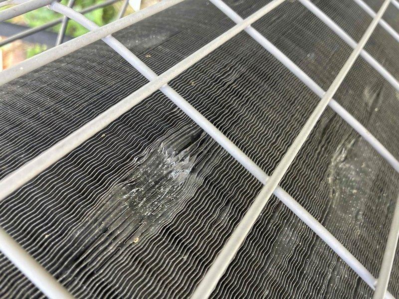 Responded to outdoor condensing unit with hail-damaged fins. Upon arrival, inspected unit and confirmed extensive fin damage affecting airflow efficiency across multiple coil sections. Performed fin combing procedure on all affected areas of condenser coils to straighten bent and compressed fins, restoring proper spacing and airflow paths. Cleaned accumulated debris from coil surfaces during repair process. Verified adequate airflow restoration through all coil sections upon completion. Unit returned to normal operating condition with improved heat transfer capability.