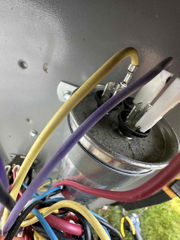 Completed routine cooling system maintenance on residential HVAC unit. Performed comprehensive inspection of electrical components including capacitor and wiring connections, verified all terminals secure with proper color-coded connections intact. Conducted amperage readings using clamp meter, confirming system drawing 0.00A at time of measurement with voltage reading of 960, indicating unit was not in active cooling cycle during testing. Inspected interior cabinet components, verified capacitor mounting and electrical connections showing normal wear consistent with operational equipment. All accessible components examined and found functioning within normal parameters. Customer advised that equipment age records require updating, as unit is approximately 2 years old rather than 8 months as currently documented in system records.
