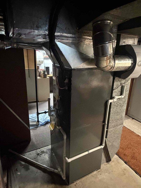 Completed full HVAC system installation including 80% efficiency furnace, air conditioning unit, and humidifier in basement location. Installed new gray metal furnace with proper ductwork connections, including both flexible and rigid metal supply ducts with reflective insulation wrapping. Verified system operation with temperature readings at 75.5°F in attic space. Secured all ductwork connections with metal clamps per code requirements and ensured proper airflow throughout the system. Final balance collected upon completion.