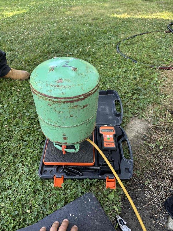 Responded to no cooling complaint on aging air conditioning system. Upon arrival, conducted diagnostic testing of outdoor condensing unit using digital refrigerant leak detector. Equipment showed significant weathering and corrosion on cabinet surfaces, indicating extended service life consistent with 10+ year age. Performed system evaluation to identify root cause of cooling failure.