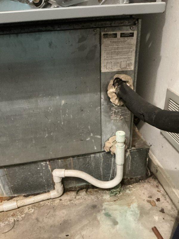Completed full system evaluation and provided replacement options for aging HVAC equipment showing significant wear and deterioration. Documented existing furnace with compromised cabinet integrity, deteriorated insulation, and accessible internal components, along with water heater and associated venting systems requiring attention for complete system upgrade planning.