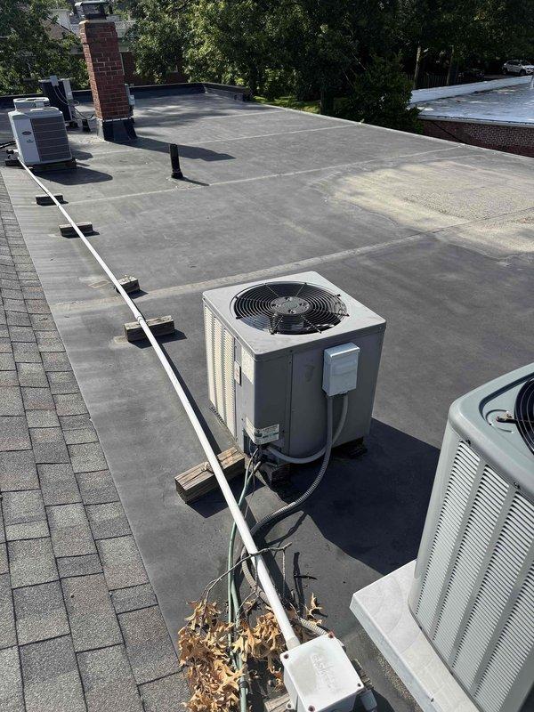 Responded to no cooling complaint on rooftop HVAC unit. Upon arrival, performed diagnostic evaluation of condensing unit and system operation. Documented equipment condition and rooftop installation with photos showing unit placement, electrical disconnect, and surrounding rooftop environment for service records.