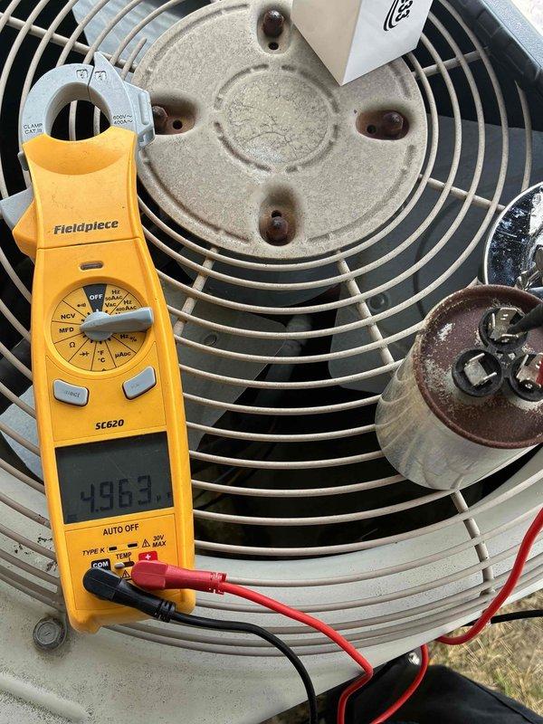 Responded to no cooling complaint on residential air conditioning system. Upon inspection, identified failed dual run capacitor on outdoor condenser unit showing significant corrosion and deterioration. Tested capacitor with digital multimeter, confirming reading of 49.6 MFD, well below manufacturer specifications. Replaced defective capacitor with new component, verified proper electrical connections, and tested system operation to ensure restoration of cooling function.