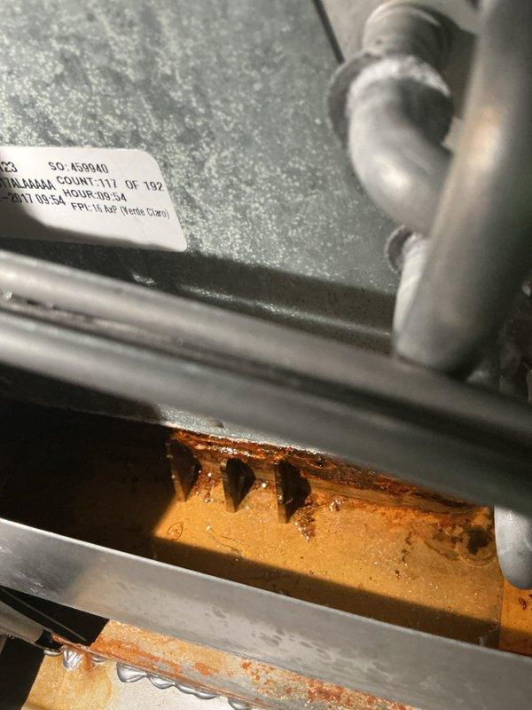 Completed cooling season tune-up on residential HVAC system. Inspection revealed significant rust and corrosion on heat exchanger base and mounting components, indicating prolonged moisture exposure that will require monitoring or future replacement. All accessible components were inspected, refrigerant lines checked, and system operational parameters verified per manufacturer specifications.