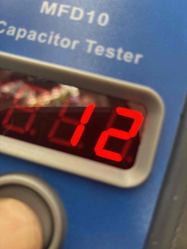 Responded to no cooling call with thermostat displaying "open start circuit" error. Upon inspection, tested the run capacitor using a digital MFD tester which confirmed capacitor failure with abnormal readings. Replaced defective dual run capacitor, verified all electrical connections were secure, and confirmed system returned to normal operation with error cleared.