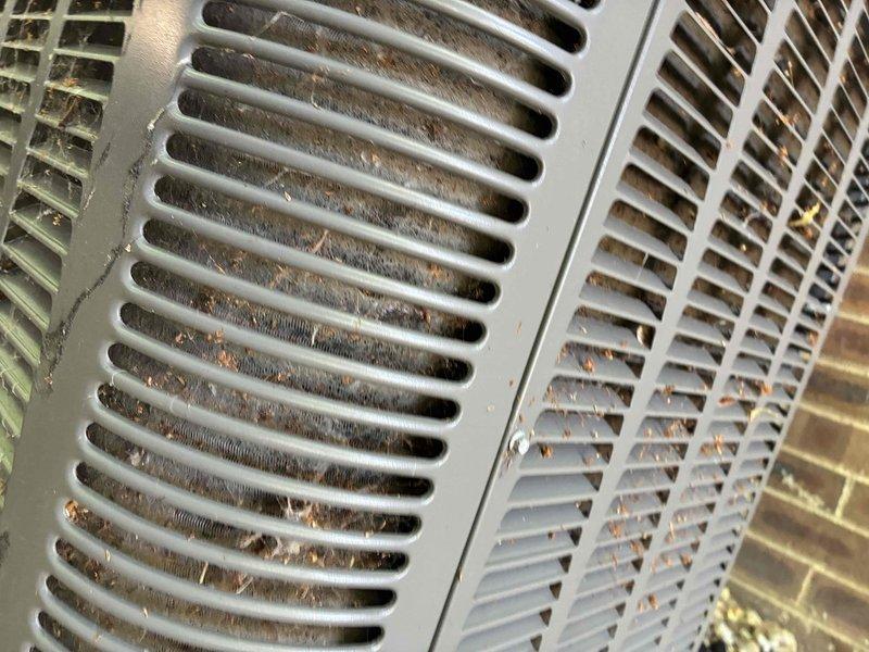 Responded to no cooling complaint at residential property. Upon arrival, performed visual inspection of HVAC system and identified severely restricted airflow due to excessive debris accumulation. Found condenser coils heavily clogged with dirt, dust, and organic material buildup between fins, significantly reducing heat transfer efficiency. Return air grilles obstructed with substantial cobweb accumulation and debris, restricting proper air circulation throughout the system. Thoroughly cleaned condenser coil fins to restore optimal heat exchange capacity. Removed all cobwebs and debris from return air vents and grilles. Cleared blockages from airflow pathways to restore proper system ventilation. Verified system operation after cleaning, confirming restored cooling functionality and adequate airflow. Unit now operating within normal parameters.
