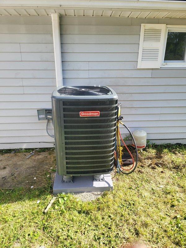 Completed installation of Goodman heat pump system including outdoor condensing unit and indoor furnace. Outdoor unit was mounted on concrete pad with proper clearances, refrigerant lines were run with insulation and connected, electrical disconnect installed, and condensate drain line plumbed with PVC. Indoor furnace was installed in mechanical closet with all necessary electrical connections, control wiring, and venting completed. System was charged, tested, and verified operational.