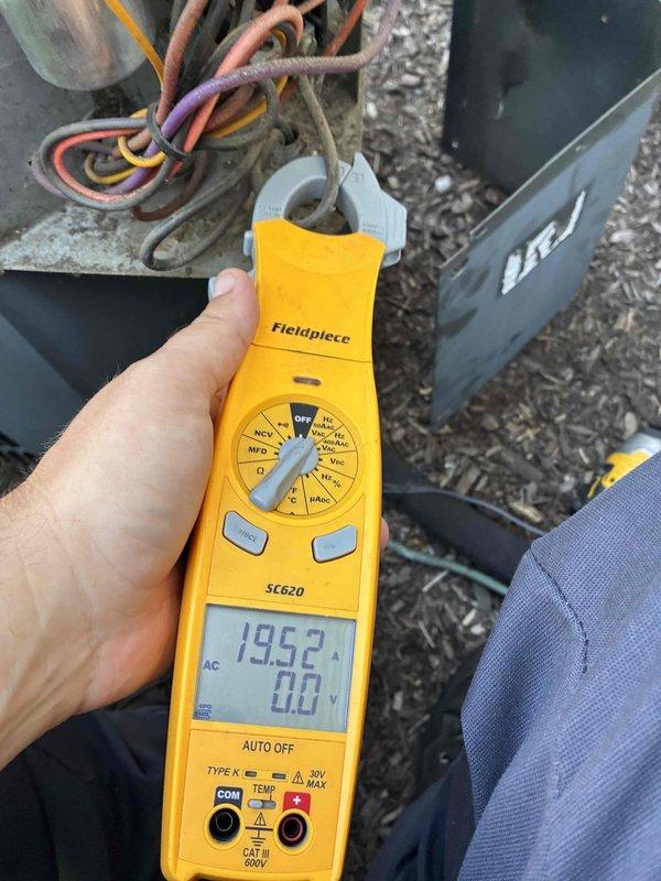 Completed preventive maintenance service on Rheem cooling system. Performed electrical diagnostics using digital multimeter, measuring amperage draw at 19.52A and capacitance reading at 5.03 MFD on system components. Inspected condenser unit, verified proper electrical connections, and tested all operating parameters. System operating within normal specifications upon completion of scheduled maintenance visit.