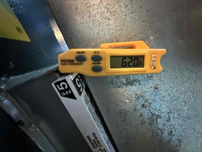Completed routine cooling system maintenance visit on residential air conditioning unit. Inspected electrical connections at terminal block, verifying secure wire terminations and proper grounding. Measured ambient temperature at equipment location reading 62.0°F. All electrical components showed normal wear patterns with connections intact and functioning within specifications. System operational and ready for cooling season.