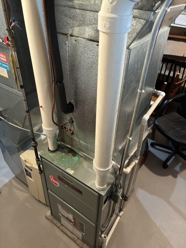 Completed full HVAC system replacement estimate for residential installation due to cracked drain pan in existing system. Assessed current Rheem furnace and air handler configuration in basement utility area, documented equipment conditions, ductwork connections, refrigerant line routing, condensate drainage system, and overall mechanical room layout to provide comprehensive replacement options for complete heating and cooling system.