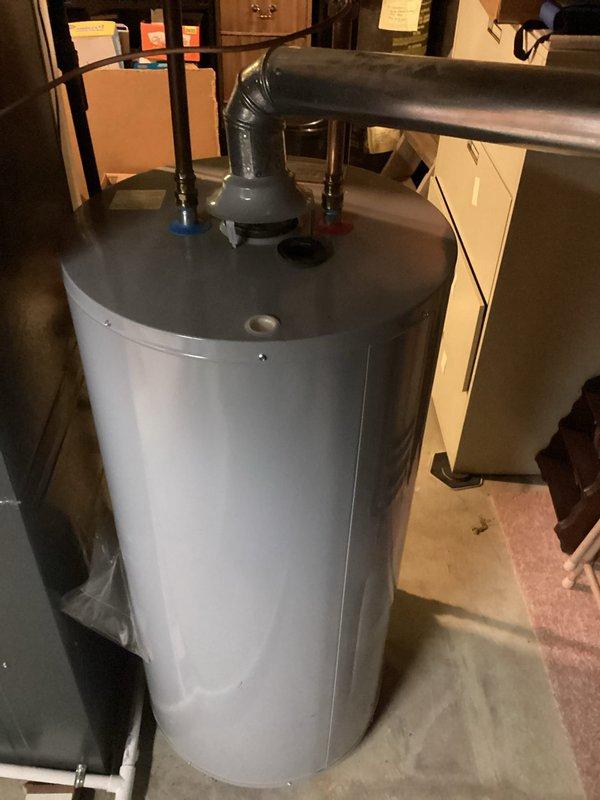 Responded to call regarding excessively hot water from A.O. Smith tanked water heater causing scalding conditions at fixtures. Upon arrival, performed visual inspection of unit and surrounding plumbing connections in basement utility area. Assessed water heater operation, temperature settings, and pressure relief valve function. Customer reported issue developed progressively over previous week with no adjustments made to equipment. Documented equipment condition and configuration with photographs showing copper supply lines, pressure relief valve, and overall installation setup for service records.