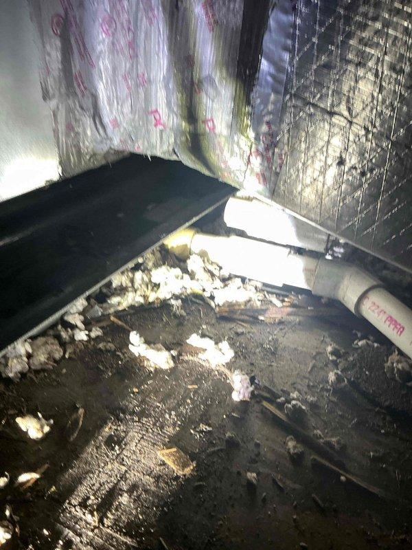 Responded to water leak complaint following recent air handler installation. Upon arrival, retrieved wet switch from shop as needed for repair. Customer reported water intrusion into bathroom from newly installed air handler unit. Inspected ceiling-mounted bathroom ventilation assembly and accessed attic space above affected area. Found evidence of moisture damage on attic flooring near air handler location, with visible water staining and wet spots present. Observed condensate drain line routing and identified improper drainage as likely cause of leak. Addressed drainage issue and installed wet switch to prevent future overflow conditions. Verified proper condensate removal and confirmed no active leaking upon completion of repairs.