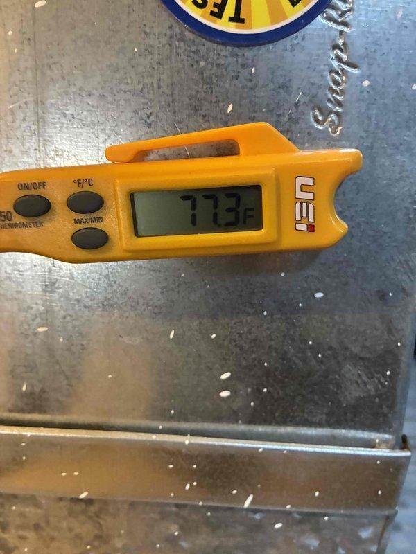 Responded to complaint of inadequate cooling and weak airflow to first and second floors following recent AC installation two months prior. Performed diagnostic testing and temperature measurements on newly installed system. Upon inspection, identified potential refrigerant line connection issues at outdoor unit, evidenced by discoloration and wear on line set fittings. Measured supply air temperature at 77.3°F, confirming insufficient cooling performance. Documented equipment condition with photos showing compromised connections and possible refrigerant leak at service ports. Recommended follow-up service to pressure test system, verify refrigerant charge levels, and inspect installation quality of line sets and electrical connections to restore proper cooling capacity to affected zones.