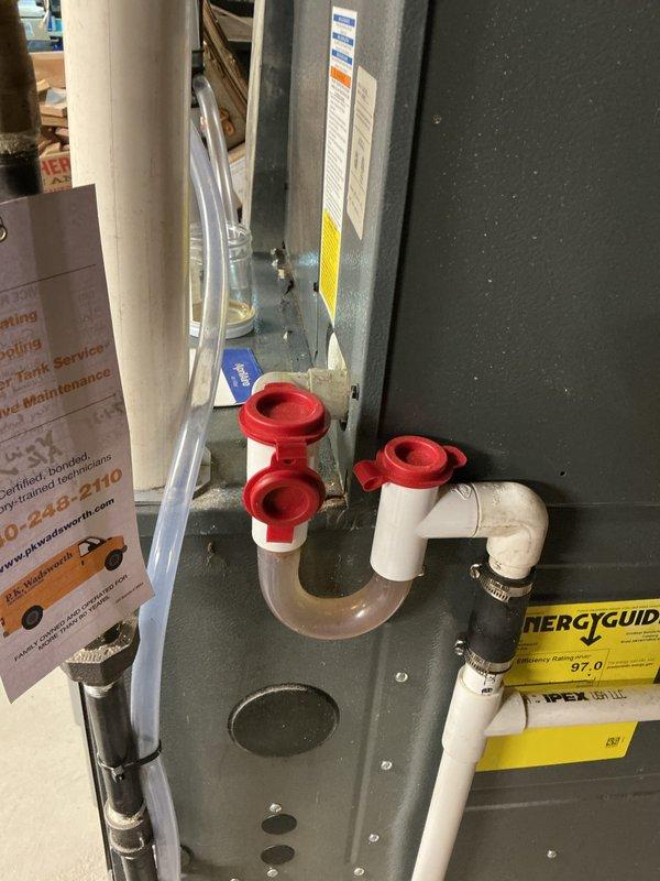 Responded to no cooling complaint on residential air conditioning system. Inspected HVAC equipment, condensate drainage system with PVC piping and red valve handles, and Aprilaire humidifier unit. System evaluated and restored to proper cooling operation.