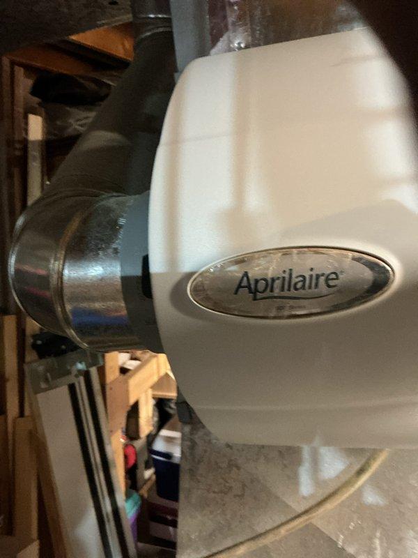 Responded to no cooling complaint on residential air conditioning system. Inspected HVAC equipment, condensate drainage system with PVC piping and red valve handles, and Aprilaire humidifier unit. System evaluated and restored to proper cooling operation.