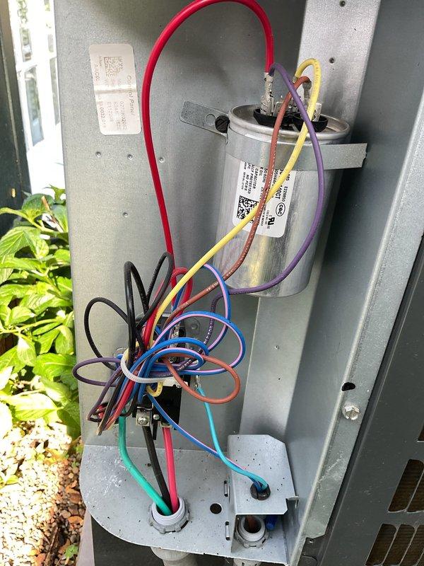 Completed scheduled preventive maintenance on residential split-system air conditioning unit. Inspected attic-mounted air handler with attached flexible ductwork and verified proper installation of condensate drain line and refrigerant lines. Examined outdoor condensing unit, checking capacitor connections and verifying all electrical wiring terminals were secure with proper color-coded connections intact. All components found to be in functional operating condition with no deficiencies requiring immediate attention.