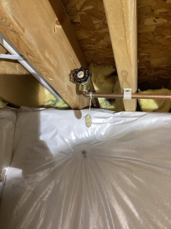 Conducted on-site assessment of exterior hose bib requiring replacement. Inspected outdoor faucet mounted on exterior wall near brick foundation and traced supply line to crawl space shut-off valve. Documented existing copper pipe configuration and valve location for quote preparation. Customer requested estimate for complete outdoor faucet replacement.
