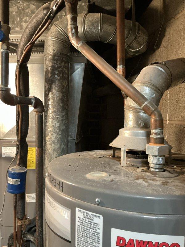 Conducted on-site evaluation for HVAC system replacement involving two complete heating and cooling systems and two additional air conditioning units, all experiencing no cooling issues. Assessed existing Luxaire furnace and associated ductwork, water heater connections, and mechanical infrastructure in basement utility area to provide replacement options and specifications for multiple system upgrades.