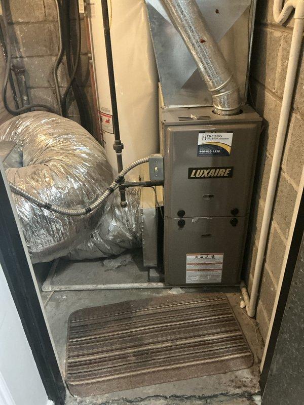 Conducted on-site evaluation for HVAC system replacement involving two complete heating and cooling systems and two additional air conditioning units, all experiencing no cooling issues. Assessed existing Luxaire furnace and associated ductwork, water heater connections, and mechanical infrastructure in basement utility area to provide replacement options and specifications for multiple system upgrades.