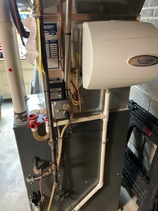 # HVAC Cooling Maintenance Summary

Completed scheduled preventive maintenance on residential cooling system including furnace, air handler, and associated refrigerant lines. Performed comprehensive inspection of all major components, verified proper operation of Aprilaire humidifier unit, checked refrigerant line connections and insulation integrity, and confirmed electrical connections throughout the system. All equipment found to be operating within normal parameters with no issues identified.

# Detailed Work Performed

Conducted routine cooling season maintenance on residential HVAC system located in basement utility area. Performed visual inspection of gray metal furnace/air handler unit, confirming proper mounting and structural integrity. Inspected Aprilaire whole-house humidifier installation and verified secure connections to main air handling unit.

Examined copper refrigerant line routing and mounting brackets for proper support and alignment. Checked insulation wrapping on