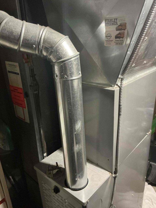 Conducted comprehensive evaluation of existing HVAC system for full replacement estimate. Home warranty company identified current furnace and air conditioning unit as potentially undersized for the residence. Performed detailed assessment of existing equipment installation in basement mechanical room, including furnace, air handler, plenum assembly, and associated ductwork configuration. Documented current system components including metallic supply plenum, galvanized metal ductwork with elbow transitions, and flexible insulated duct runs. Evaluated equipment capacity requirements and existing distribution system to determine appropriate replacement sizing options. Provided multiple replacement system options to address undersizing concerns and ensure adequate heating and cooling capacity for the home.