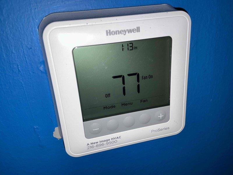 Conducted comprehensive HVAC system evaluation for equipment replacement estimate. Assessed existing outdoor air conditioning condenser unit and indoor climate control components, documenting current system configuration including exterior condensing unit positioned on concrete pad with protective platform, associated refrigerant line routing, and electrical connections. Reviewed interior thermostat functionality and compatibility requirements for potential system upgrade, photographed equipment specifications and installation details to provide accurate replacement options for complete HVAC system modernization.