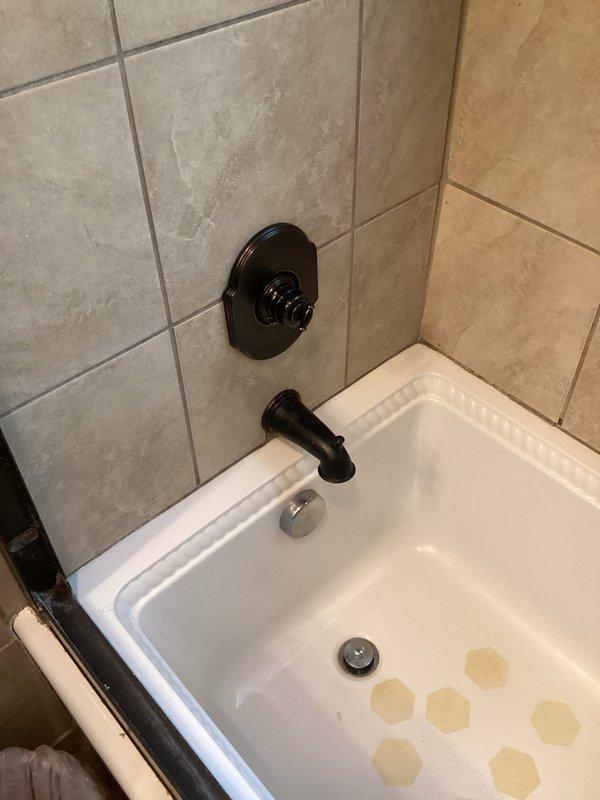 Conducted site assessment for upcoming plumbing fixture replacement project. Evaluated existing bathroom installations including main shut-off valve, two faucet assemblies, bathroom sink with integrated countertop, and shower head fixture requiring replacement. Documented current conditions of oil-rubbed bronze tub/shower controls, black two-handle lavatory faucet, and beige cultured marble vanity top with integrated basin. Reviewed scope of work for fixture changeouts and custom channel installation, noting all replacement parts provided by property owner.