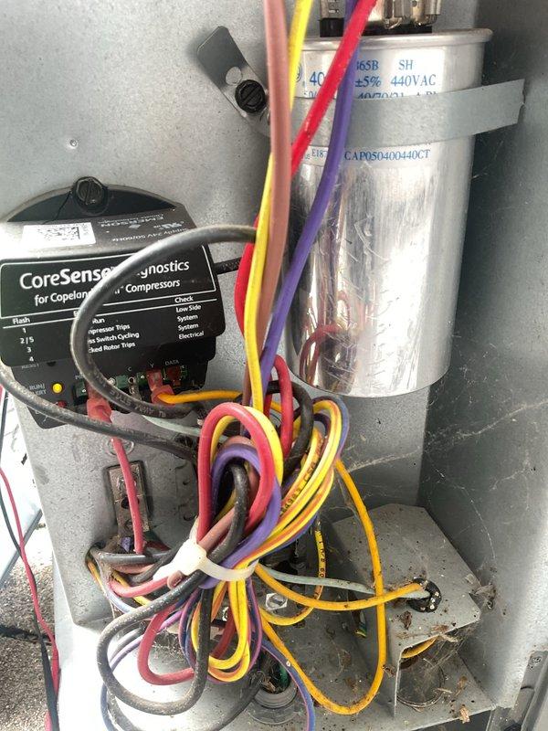 Performed comprehensive cooling system tune-up including inspection of electrical components, capacitor, and CoreSense compressor diagnostic module. Verified system operation, checked refrigerant temperatures showing -35.0°F readings, and confirmed proper ductwork installation and sealing integrity.