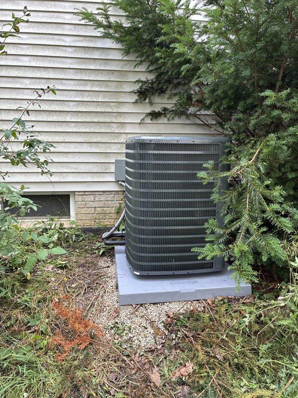 Completed installation of new residential air conditioning system. Installed outdoor condensing unit on existing concrete pad adjacent to building exterior with proper clearances maintained. Ran electrical disconnect and conduit from building-mounted disconnect box to unit per code requirements. Verified all electrical connections, tested system operation, and confirmed proper unit function upon startup.