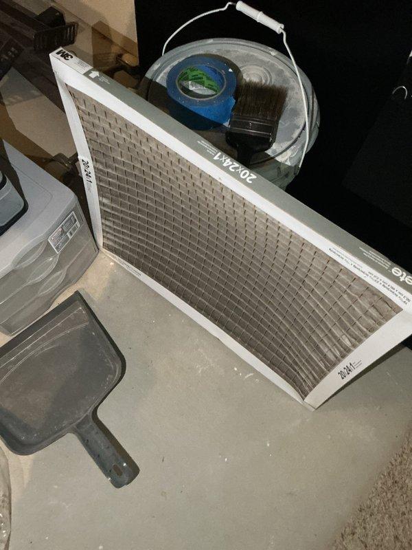 Responded to service call for 13-year-old air conditioning system not cooling effectively and water accumulation near furnace area. Upon inspection, found severely restricted airflow due to clogged air filter requiring immediate replacement with new 20x24x1 filter. Identified condensate drainage issue causing water pooling on floor around HVAC cabinet, evidenced by significant water staining and discoloration on flooring surface. Cleared condensate drain line blockage and verified proper drainage through PVC drain piping. System tested and confirmed restored cooling capacity and proper condensate removal.