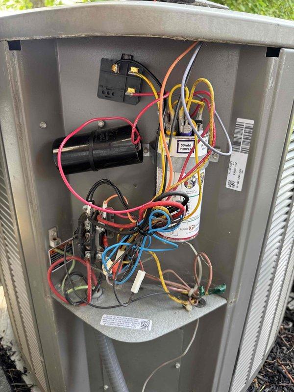Responded to no cooling complaint on residential HVAC system. Upon arrival, inspected outdoor unit electrical compartment and found all wiring connections intact with capacitor and contactor properly mounted. Verified electrical panel breakers were in correct positions with no tripped circuits. System components showed normal wear for age with no immediate electrical failures detected in control circuit or power supply.