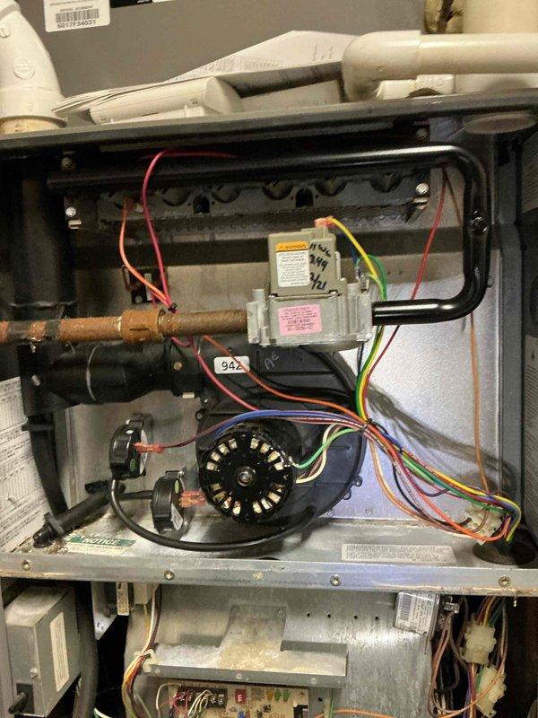 Responded to no cooling complaint with thermostat set to 72°F but reading 78°F with minimal airflow from supply vents. Inspected HVAC system interior components including blower motor assembly, control board, transformer, and electrical connections. Documented internal system condition showing operational wear and dust accumulation on blower assembly and control components for service records.