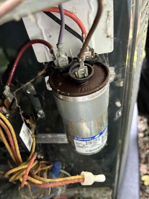 # HVAC Service Completed

Responded to no cooling call with system not turning on. Upon arrival, performed electrical diagnostics on outdoor condensing unit. Used digital multimeter to test capacitor voltage and continuity. Inspection revealed failed dual run capacitor with visible signs of deterioration including rust and corrosion on terminals. Capacitor tested outside acceptable microfarad range, preventing compressor and condenser fan motor from starting. Replaced defective capacitor with new unit matching proper specifications. Verified all electrical connections secure and tested system operation. Unit now cooling properly with compressor and fan motor running within normal parameters.