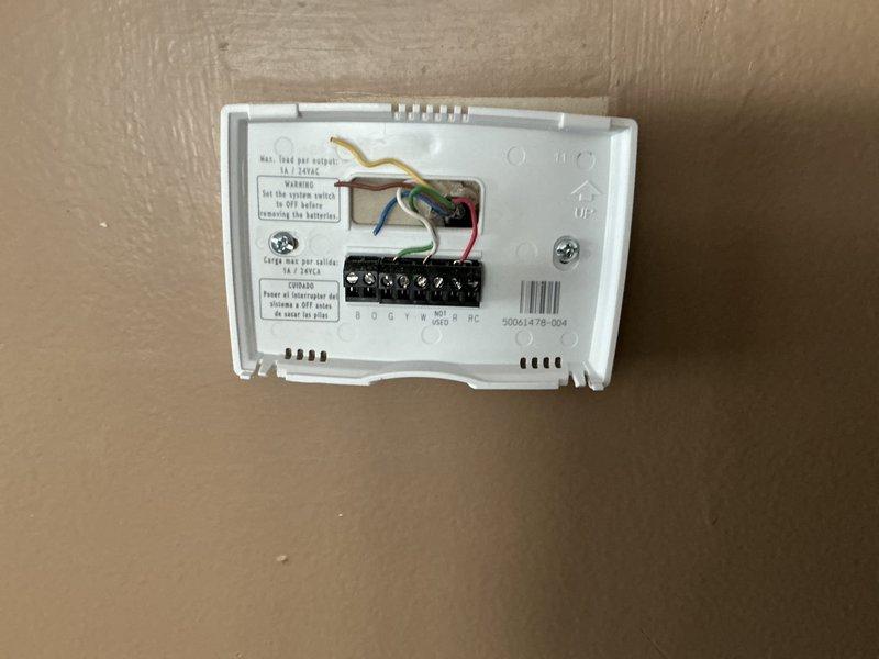 Conducted on-site assessment for furnace replacement in residential property. Evaluated existing Carrier heating unit located in basement utility area and documented current thermostat wiring configuration showing standard HVAC terminal connections (RC, W, Y, G, O, B terminals with corresponding colored wires). Presented homeowner with multiple furnace replacement options for complete system upgrade. Property currently has heating only with no air conditioning system installed.