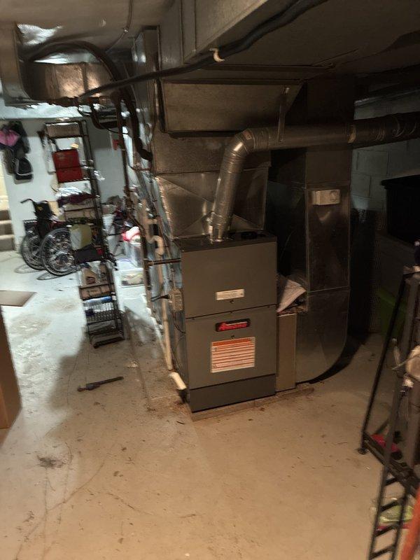 Completed installation of a new 80% efficiency furnace and air conditioning system as a secondary HVAC unit for the residence. The exterior AC condenser unit, an Amana brand model, was positioned on a concrete pad against the building foundation alongside the existing system, with proper electrical disconnects mounted on the exterior wall and conduit connections installed per code. Inside the basement mechanical room, installed the new furnace with complete ductwork distribution system extending from the unit to service the designated zones. All refrigerant lines were run between the indoor and outdoor components, properly insulated and secured. System was charged to manufacturer specifications, tested for proper airflow and temperature differential, and verified all electrical connections and safety controls are functioning correctly. Both heating and cooling modes were cycled and confirmed operational.