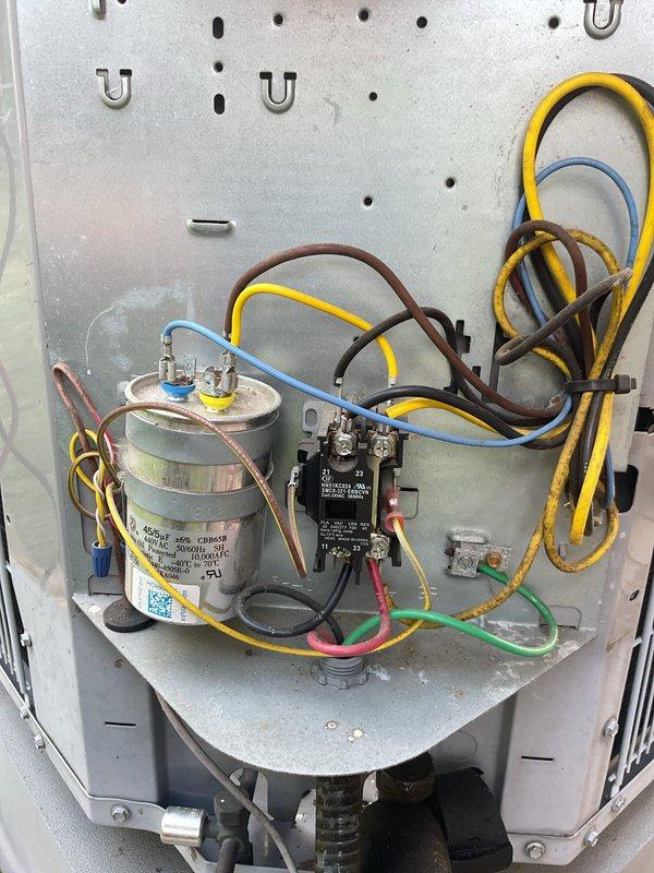 Completed cooling system tune-up on Carrier outdoor condenser unit. Inspected electrical components including capacitor and contactor, verified all wire connections secure, and confirmed system operation. Unit found in good working condition with all components functioning properly.