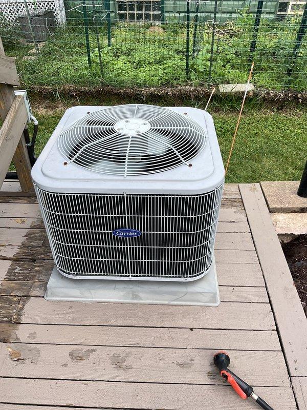 Completed cooling system tune-up on Carrier outdoor condenser unit. Inspected electrical components including capacitor and contactor, verified all wire connections secure, and confirmed system operation. Unit found in good working condition with all components functioning properly.