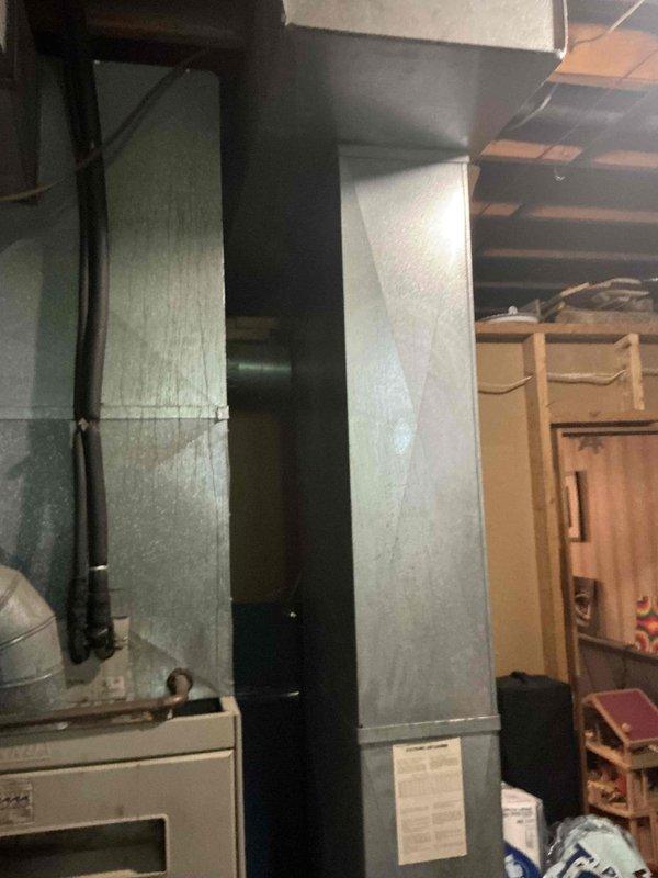 Conducted full system assessment on non-functional Lennox HVAC system with no cooling capability. Presented three complete replacement options featuring Goodman air conditioning and gas furnace combinations: Good tier system with up to 13.4 SEER and 80% AFUE efficiency ratings, Better tier system with up to 14 SEER and 96% AFUE ratings, and Best tier system with up to 16 SEER and 96% AFUE ratings. Documented existing outdoor electrical disconnect box showing weathering and age-related deterioration, as well as current basement ductwork configuration and equipment layout for replacement planning purposes.