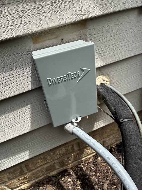 Completed full HVAC system installation including 96% efficiency furnace, air conditioning unit, air scrubber, and 8000 BTU capacity equipment. Installed new disconnect box with Littelfuse FLNR 30A Class RK5 time-delay dual element fuses rated for 250 VAC, mounted weatherproof DiversiTech utility enclosure on exterior wall with proper conduit routing including insulated refrigerant lines and PVC drainage. System tested and operational upon completion.