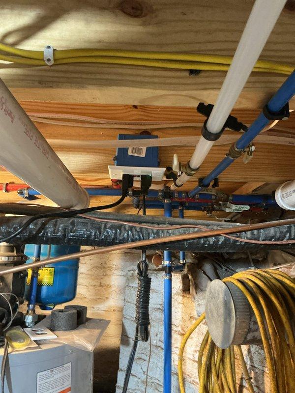 Conducted comprehensive electrical inspection of residential crawl space and mechanical room installations. Verified proper routing and securing of yellow electrical conduit with appropriate mounting clips to floor joists, ensuring compliance with code requirements for protection and support spacing. Inspected junction box installation in mechanical area with gray conduit entry points, confirmed wire connections utilizing red and black terminal blocks, and verified proper box mounting to wall surface. Documented all electrical components, conduit pathways, and wire management systems through detailed photography for record-keeping purposes. All observed installations met current electrical code standards for residential applications.