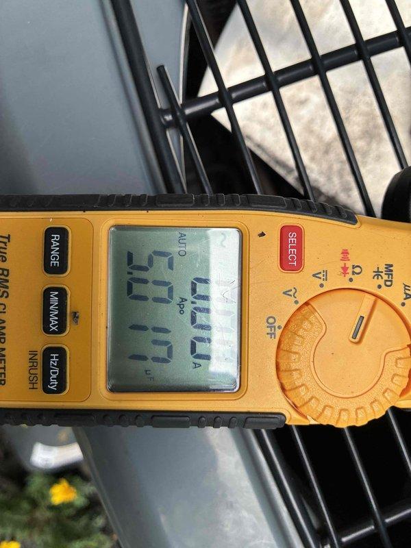 # HVAC Cooling Maintenance Summary

Completed comprehensive preventive maintenance service on residential air conditioning system. Performed electrical diagnostics using digital multimeter, verifying system amperage draw at 23.0 amps within normal operating parameters. Inspected and tested dual-run capacitor (45/5 MFD, 440VAC) manufactured by Tongfeng Electronics, confirming proper electrical ratings and secure mounting. All electrical connections, terminals, and wiring found in satisfactory condition with no signs of degradation or overheating. System operating efficiently with all components functioning within manufacturer specifications.