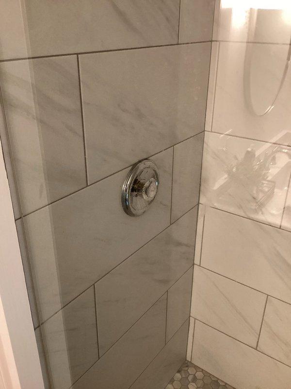 Responded to service call for historic farmhouse bathroom shower system. Successfully replaced failed Moen balancing valve in existing shower installation. Accessed plumbing assembly through wall panel, removed corroded valve assembly, and installed new pressure-balancing valve to restore proper temperature control and water flow to the shower fixture.